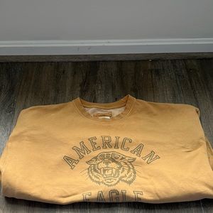 Long sleeved mustard colored American Eagle sweatshirt.